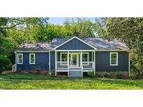 Charming blue house with white trim and a welcoming front porch at 1624 Venetian Sw Dr, Atlanta, GA 30311
