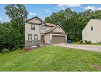 Charming two-story home featuring stone accents, a front-facing garage and a well-maintained lawn at 148 Shady View Pl, Lawrenceville, GA 30044