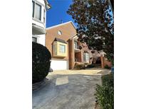 Brick home with attached two-car garage and manicured landscaping at 409 Angier Ne Ct, Atlanta, GA 30312