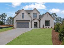 Two-story brick house with gray doors, and a landscaped lawn at 315 Hillcrest View Dr, Suwanee, GA 30024