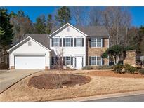 Two-story house with stone accents, white siding, and a two-car garage at 42 Millstone Gln, Dallas, GA 30157