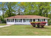 Charming, freshly painted, single-story home with a well-manicured lawn and tasteful landscaping at 132 Arnold Pl, Jonesboro, GA 30236