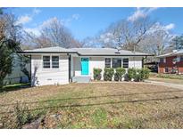 Newly renovated single-story home with a teal door and well-manicured lawn at 2131 Ben Hill Rd, Atlanta, GA 30344