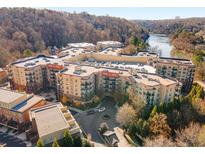 Aerial view of a luxury apartment building with river views and ample parking at 200 River Vista Dr # 330, Atlanta, GA 30339