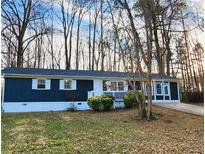 Newly painted blue house with white trim, landscaping, and a long driveway at 212 Valerie Cir, Hiram, GA 30141