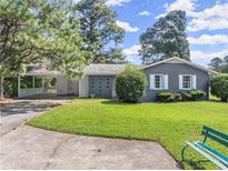 Gray brick ranch house with a large yard and carport at 3971 S Hurt Rd, Smyrna, GA 30082