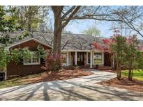 Brick ranch home with mature landscaping and a large driveway at 10170 Cedar Grove Rd, Chattahoochee Hills, GA 30213