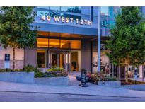 Building entrance at 40 West 12th featuring well manicured landscaping and a covered entry at 40 12Th Ne St # 1701, Atlanta, GA 30309