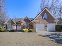 Brick house with two-car garage and manicured lawn at 4251 Sheffield Nw Ct, Kennesaw, GA 30144