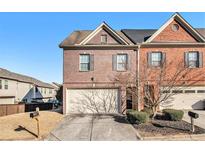 Brick front townhouse with attached garage and landscaping at 7165 Fringe Flower Dr # 5, Austell, GA 30168