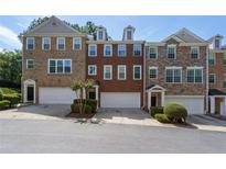 Three-story townhouses with brick exteriors and attached garages at 4693 Creekside Villas Se Way, Smyrna, GA 30082