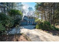 Two-story blue house with attached garage and landscaping at 4618 Shallowford Rd, Roswell, GA 30075