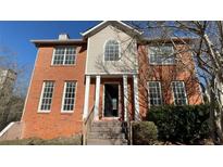 Two-story brick home with a gable roof and white-trimmed windows at 4990 Windsor Downs Dr, Decatur, GA 30035
