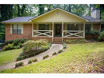 Brick ranch house with covered porch and landscaped yard at 3870 N Shelby N Ln, Douglasville, GA 30135