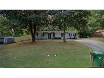 Ranch style home with a large front yard and mature trees at 4239 Canby Ln, Decatur, GA 30035