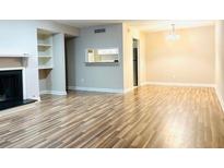 Spacious living room features hardwood floors, fireplace, and built-in shelving at 1011 Dunbar Dr, Atlanta, GA 30338