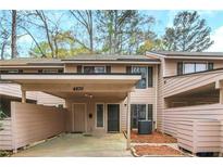 Charming townhouse featuring a covered carport and a cozy front entrance, perfect for convenient living at 4870 Twin Lakes Trl, Atlanta, GA 30360