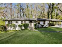 Ranch style home with white brick exterior, landscaped lawn, and covered carport at 1544 Austin Rd, Atlanta, GA 30331