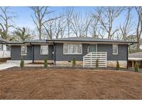 Newly renovated ranch home with gray brick exterior and modern landscaping at 1682 Valencia Rd, Decatur, GA 30032