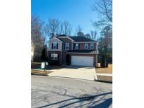 Charming two-story home featuring a wide driveway and attached two-car garage at 1963 White Top Rd. Se, Lawrenceville, GA 30045