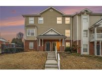 Two-story townhome with brick and siding exterior, steps leading to the entrance at 277 Ralph David Abernathy Sw Blvd, Atlanta, GA 30312