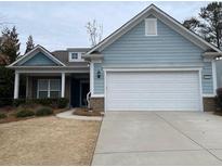 Ranch style home with light blue siding, white garage door, and landscaping at 4338 Braden Nw Ln, Kennesaw, GA 30144