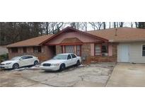 Brick ranch home with attached garage and driveway at 1058 Viking Dr, Stone Mountain, GA 30083