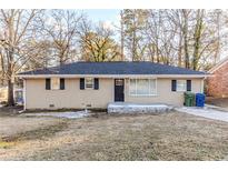 Brick ranch house with a well-maintained lawn at 3489 Pine Forest Se Dr, Atlanta, GA 30354