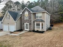 Two-story house with stone accents and a large yard at 3877 Oakman Pl, Fairburn, GA 30213