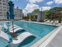 Resort-style swimming pool with lounge chairs and shaded cabana area, perfect for relaxation at 2520 Peachtree Nw Rd # 1202, Atlanta, GA 30305