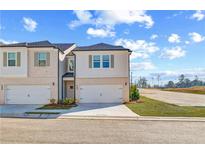 Charming townhome with a one-car garage and inviting curb appeal on a sunny day at 329 Shine Dr, Stockbridge, GA 30281