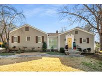 Charming home featuring a stone pathway, well-kept lawn, and a welcoming yellow front door at 3495 Habersham Nw Rd, Atlanta, GA 30305