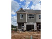 New construction home showcasing a modern facade with gray siding and a single-car garage under construction at 2800 Lillian Ln, Douglasville, GA 30135