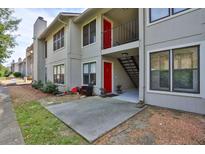 Condominium with a small patio and red doors at 1414 Branch Dr, Tucker, GA 30084