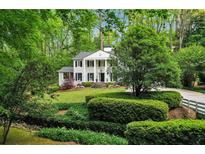 Charming two-story home with manicured lawn and lush landscaping at 2562 Red Valley Nw Rd, Atlanta, GA 30305
