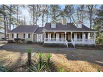 Ranch style home with large front porch and mature trees at 3281 Old Salem Rd, Conyers, GA 30013