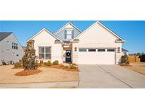 Charming single-story home with a well-manicured lawn and attached two-car garage at 412 Southbridge Pass, Peachtree City, GA 30269