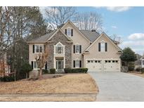 Two-story house with stone accents and a three-car garage at 1354 Benbrooke Nw Ln, Acworth, GA 30101