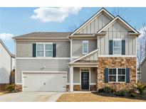 Charming two-story home with stone accents, a two-car garage, and beautiful curb appeal at 251 Ivy Chase Loop, Dallas, GA 30157
