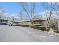 View of complex with ample parking and mature landscaping on a sunny day at 2901 Lenox Ne Rd # 506, Atlanta, GA 30324