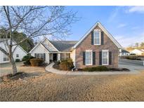 Brick and siding ranch home with landscaped yard and walkway at 2650 Hamilton Chase Run, Buford, GA 30519