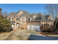 Brick house with a three-car garage and manicured lawn at 1211 Grand View Se Dr, Mableton, GA 30126