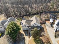Aerial view of a two-story home, showcasing its landscaping and backyard at 232 Taylors Farm Dr, Canton, GA 30115