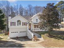 Two-story house with attached two-car garage, front porch, and landscaped yard at 232 Taylors Farm Dr, Canton, GA 30115