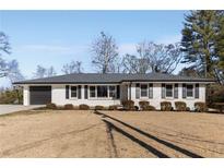 Ranch style home with white brick, black shutters, and a two-car garage at 2488 Elizabeth Ann Ne Ln, Atlanta, GA 30324