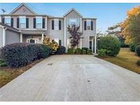 Attractive townhome with paved driveway and landscaping at 1533 Gathering Pl, Cumming, GA 30040