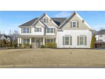 Two-story house with white siding, gray shutters, and a stone accent at 6850 Canyon Creek Way, Cumming, GA 30028