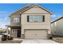 Two-story house with two-car garage and landscaped yard at 11704 Stovall Pl, Hampton, GA 30228