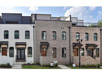 Three-unit townhome development showcasing modern brick exteriors and rooftop decks at 332 Sugarview Rd # 16, Sugar Hill, GA 30518