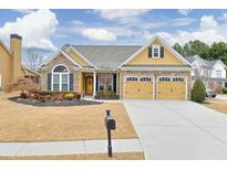 Beautiful ranch home with stone accents, two-car garage, and manicured lawn at 511 Millside Trl, Canton, GA 30114